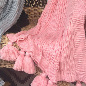 Pink knitted texture blanket with chunky tassels, throw